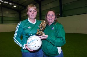 Kyla Trainor of Downpatrick Ladies FC receives the NIWFA player of the season award from team coach Michelle Madine.