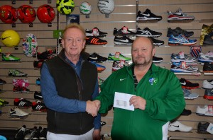 Paul McCartan from McCartan Sports Downpatrick presents Downpatrick FC's Thomas Leckey with a sponsorship cheque