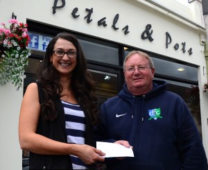 Courtney Moore from Petals & Pots presents Eugene Milligan with a sponsorship cheque