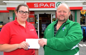 Eimear Mageean from Quinn's Spar, Saul Road, Downpatrick presents Thomas Leckey with a sponsorship cheque
